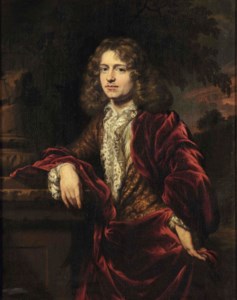 Portrait of a gentleman, three-quarter-length, in a white lace trimmed chemise and a red cloak over a gold brocate jacket, standing by a classical column in a park landscape