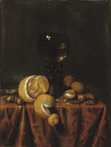 A 'Roemer' of white wine, a partially peeled lemon, walnuts and hazelnuts, all on a draped table