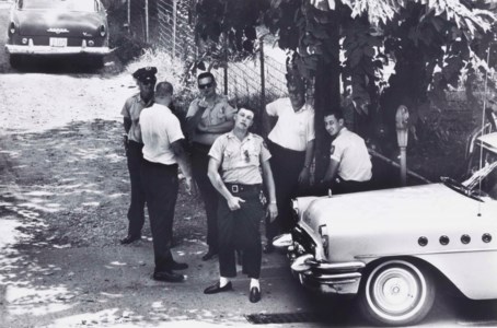 Police pose for a photograph as ministers from the National Council of Churches march to a local church, Clarksdale, Mississippi, 1963