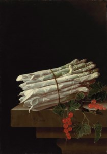 Asparagus and red currants on a stone ledge