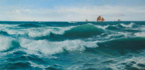 Waves breaking in shallow waters with boats off to the fishing grounds beyond