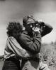 The photographer Peter Stackpole holding his camera with a young woman