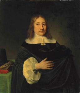Portrait of a gentleman, half-length, in a black mantle with a lace collar and cuffs, his hat and gloves on the table behind him