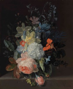 A rose, a snowball, daffodils, irises and other flowers in a glass vase, on a stone ledge