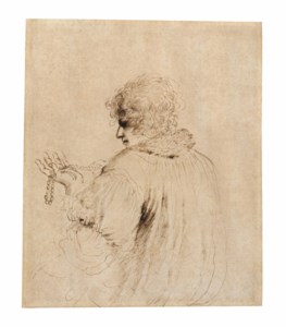 A man holding a string of beads, possibly a rosary
