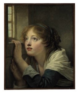 A young girl at a window