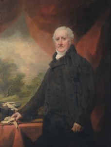 Portrait of a gentleman, traditionally identified as Andrew Wauchope of Niddrie (1711-1784), three-quarter-length, in a black coat, his right hand resting on a red draped table with his gloves and top hat, a draped curtain and mountainous wooded landscape beyond