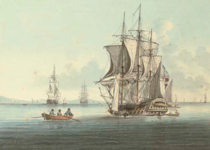 A two-decker lying at anchor, drying her sails as she takes on stores