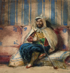 A man in Oriental costume smoking on a sofa