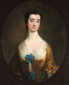Portrait of a lady, half-length, in a yellow dress with blue bows, feigned oval