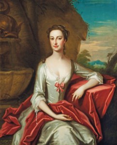 Portrait of Anne Columbine (c.1711-1771), three-quarter-length, in a white silk dress, leaning on a draped stone ledge in a garden