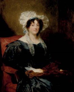 Portrait of a lady, three-quarter-length, seated in a black dress and white lace bonnet holding a shawl