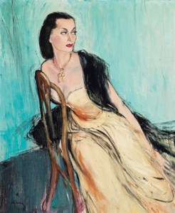 A portrait of Maggy Sarrange, three quarter length, seated, wearing a yellow dress, golden necklace and black shawl