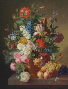Peonies, roses, tulips, an iris and other flowers in an alabaster vase on a stone ledge with fruit