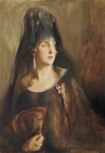 Portrait of Queen Victoria Eugenia of Spain (1887-1969), half-length, wearing a plain sleeveless black gown, the Order of Queen María Luisa on a purple and white ribbon pinned to her dress, holding a fan in her right hand
