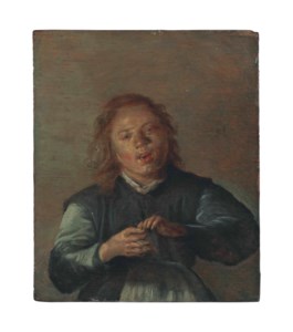 A boy singing and playing the clapper