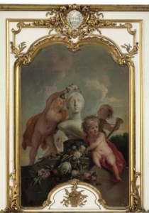 Putti decorating a sculpture with flower garlands