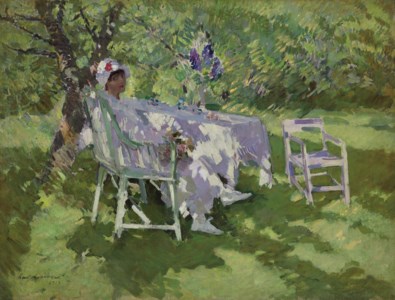 A lady in white seated in a garden