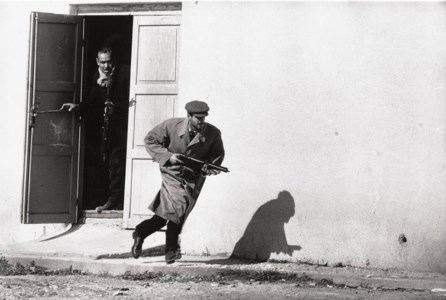 Turkish Cypriot sprinting from a cinema door under fire, Limassol, Cyprus, 1964