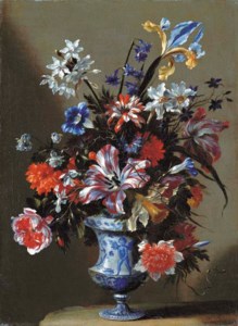 Lilies, peonies, narcissi, morning glory and other flowers in a blue and white vase on a stone ledge