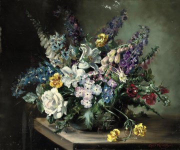 Delphiniums, digitalis, oriental lilies, roses, carnations and peonies in a vase on a wooden ledge