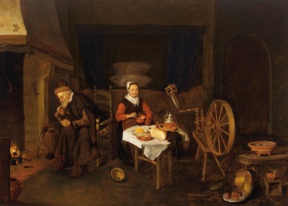 An interior with an elderly couple by a fireplace, table and spinning wheel, a bedstead behind