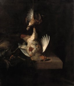 A partridge and other birds hanging above a draped stone ledge along with hunting paraphernalia and small birds