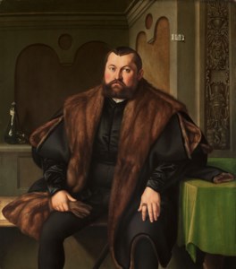 Portrait of Sigismund Baldinger (1510-1558), three-quarter-length, seated, in a black satin doublet and a fur-lined black mantle, holding gloves, at a draped table