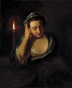 A young girl reading by candlelight