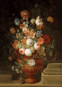 Flowers in a terracotta vase on a stone ledge