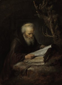 A hermit saint reading in a cave