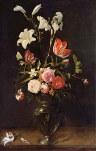 Lilies, roses and tulips in a glass vase on a wooden ledge with butterflies
