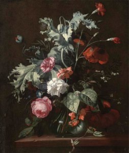 Roses, morning glory and other flowers in a glass vase on a wooded ledge