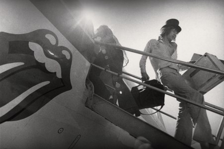 Mick Jagger disembarking from plane, c. 1972