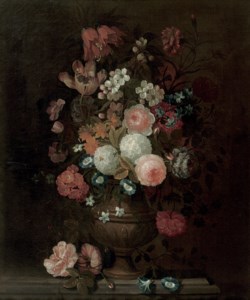Roses, tulips, carnations, morning glory and various other flowers in a vase, on a stone ledge