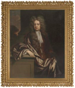 Portrait of a gentleman, three-quarter-length, in a brown coat and wrap, his right arm resting on a plinth, a landscape beyond