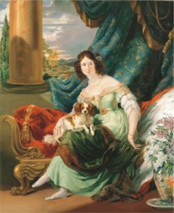 Portrait of Charlotte, Countess de la Bourdonnaye (1795-1875), full-length, in a green dress, seated on a day bed on a terrace, a dog on her lap, before a draped curtain, with an extensive landscape beyond
