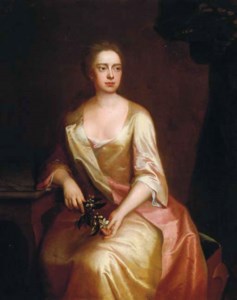 Portrait of a lady, three-quarter-length, seated, in a golden satin dress holding a spray of flowers