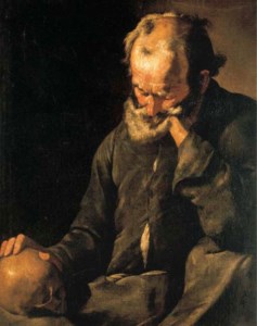A bearded old man holding a skull