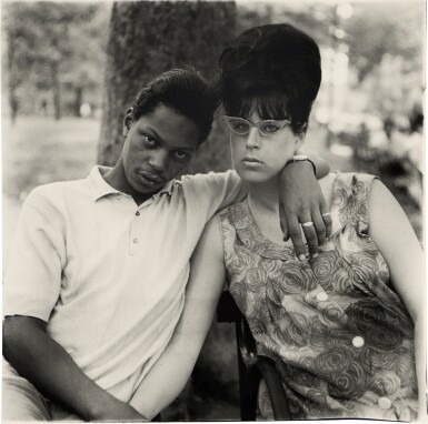 A young man and his pregnant wife in Washington Square Park, NYC