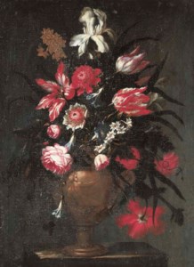 Irises, tulips, roses and other flowers in a sculpted vase
