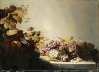 Grapes on a stone ledge with citrus fruits in a basket