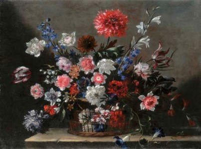 Poppies, tulips, morning glory and other flowers in a basket on a stone ledge