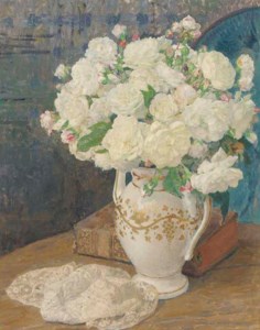 White roses in a vase, a lace handkerchief and a book on a table in an interior