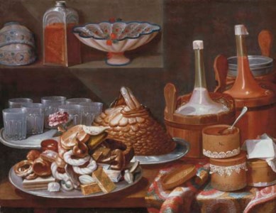 Cakes, bread, fruit, a rose, savoiardi biscuits and glasses on pewter plates with bottles in pails and decorated boxes on a partly draped table, white and blue porcelain cups and bowls with a glass jar on a ledge