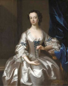 Portrait of Mary Rand, half-length, seated, in an oyster-satin dress with blue ribbons, holding a string of pearls, in an interior by a blue velvet curtain