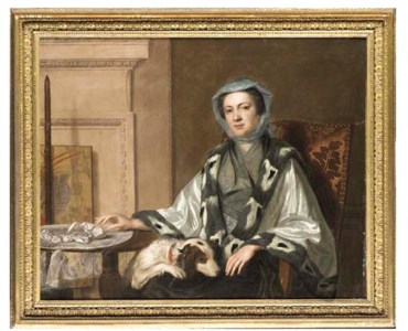 Portrait of Mrs Neate, of Donnington, Hampshire, half-length, in an embroidered silver shawl trimmed with fur, seated by a table with a spaniel her lap, in an interior, beside a polescreen
