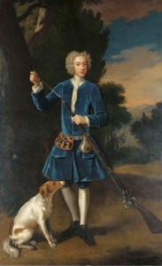 Portrait of a gentleman, full-length, in a blue velvet coat, loading his gun, a spaniel at his side, in a landscape