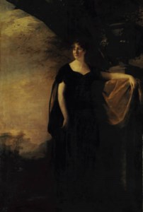 Portrait of a Margaret Stark, Mrs Drummond, full-length, in a black dress and cloak, her left arm resting on the base of a classical urn, in a landscape