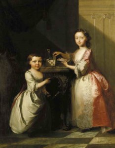 Portrait of two young children, full-length, the elder girl building a house of cards on a marble topped table, the younger child playing with a walking stick, in an interior
